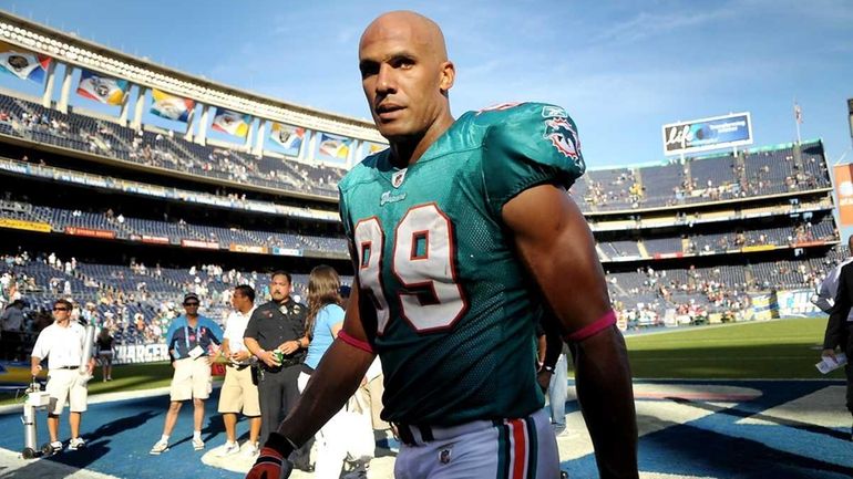 Miami Dolphins' Jason Taylor walks off the field at the...