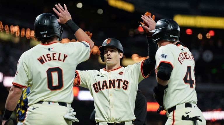 San Francisco Giants' Mike Yastrzemski, center, celebrates with Brett Wisely,...