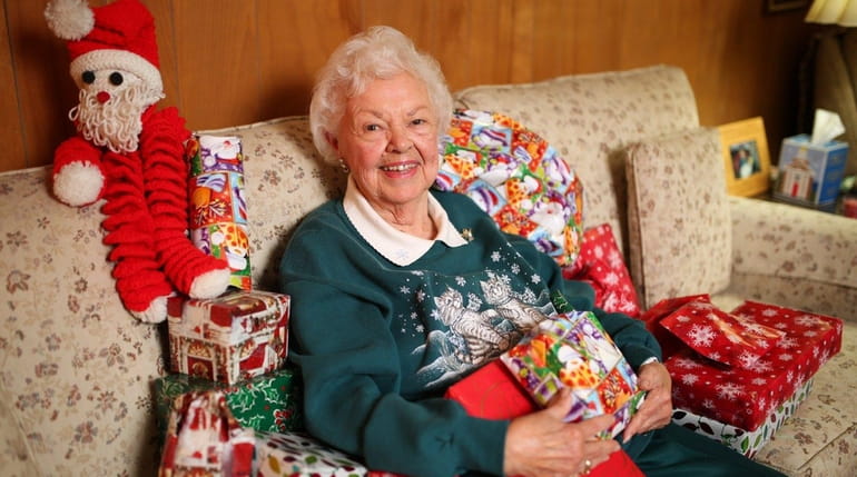 Gladys Fristrom, 89, surrounded by Christmas gifts sent from California...