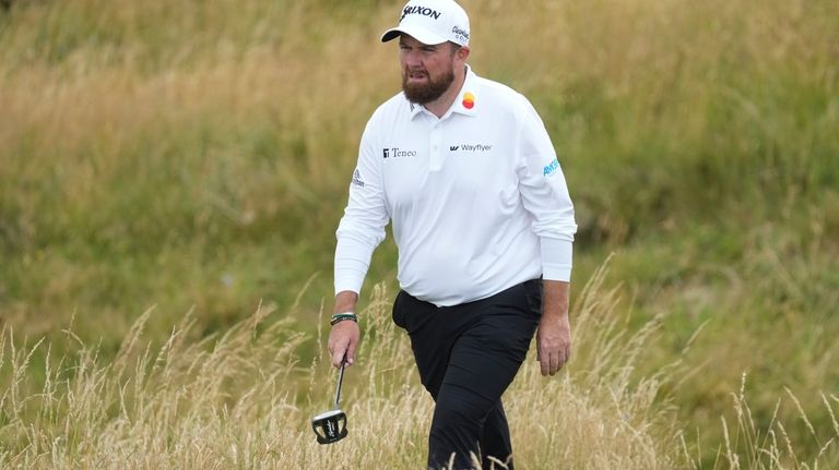 Shane Lowry of Ireland walks to the eighth green during...