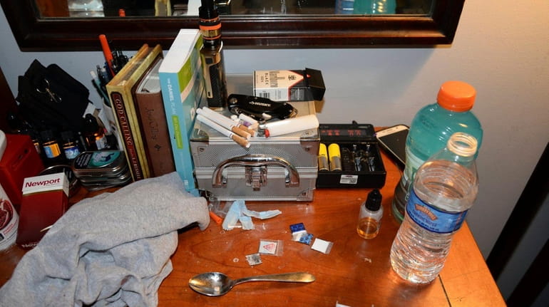 Opioid drug packets, a syringe and other belongings found by...