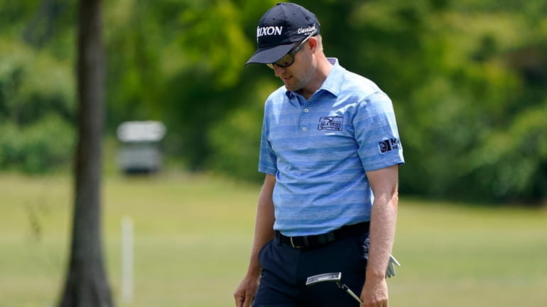 Russell Knox, of Scotland, reacts to his putt on the...