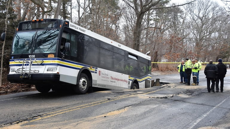 A Suffolk County Transit bus sits in a sinkhole on...