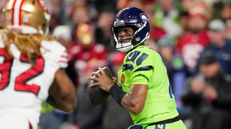 Seattle Seahawks quarterback Geno Smith throws during the first half...