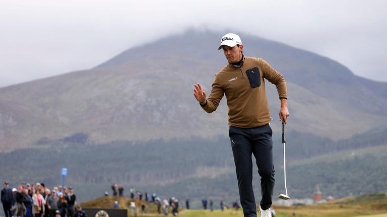 Matteo Manassero waves after putt on the sixth green during...