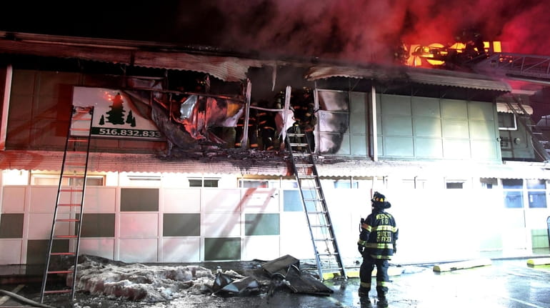 Firefighters battle a blaze at the Pines Motor Lodge in Westbury...