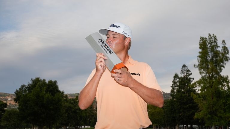 Patton Kizzire kisses the trophy after winning the Procore Championship...