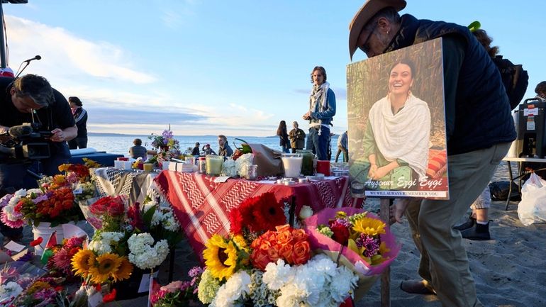 A photo is placed among flowers in memory of the...