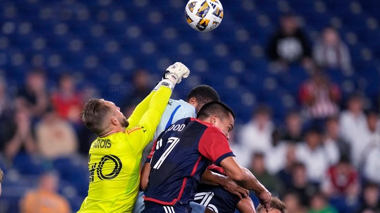 CF Montréal goalkeeper Jonathan Sirois (punches the ball away from...