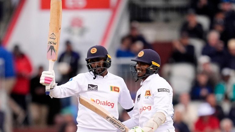 Sri Lanka's Milan Rathnayake celebrates reaching his half century on...