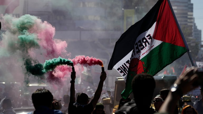 Demonstrators march during a pro-Palestinian protest, Saturday, Oct. 14, 2023,...