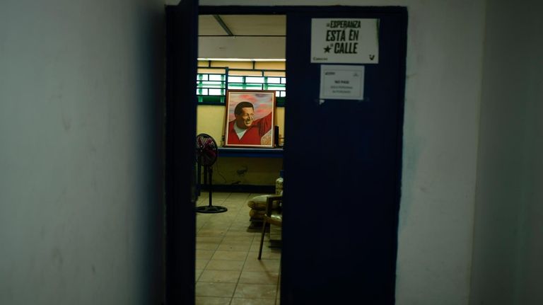 A painting of late Venezuelan president Hugo Chavez is seen...