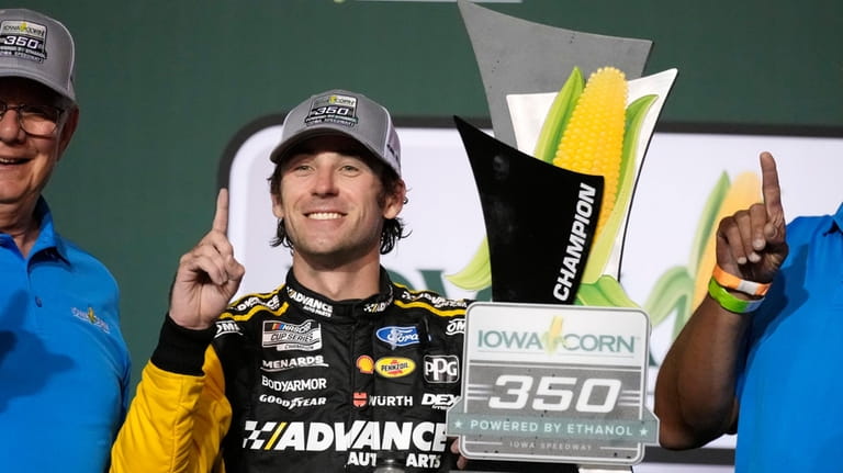 Ryan Blaney celebrates in victory lane after winning a NASCAR...