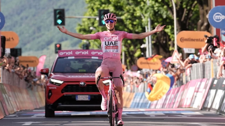 Slovenia's Tadej Pogacar, wearing the pink jersey of the race...