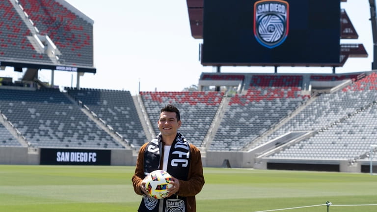 Hirving "Chucky" Lozano poses with a San Diego FC scarf...