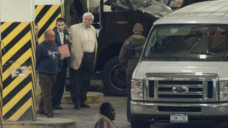 Two defendants (wearing a Yankees shirt and white suit coat)...