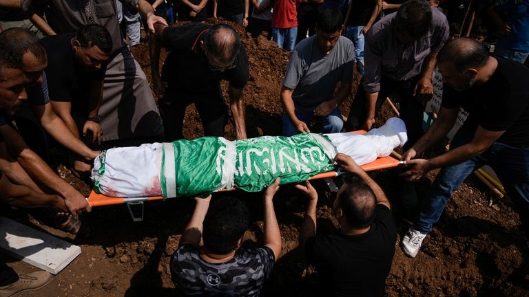 Mourners carry the body of Loujain Muslah, 16, wrapped with...