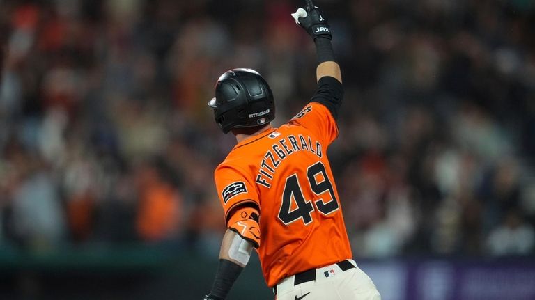 San Francisco Giants' Tyler Fitzgerald runs the bases after hitting...