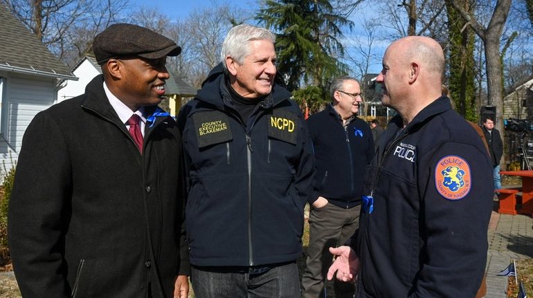 Nassau County Executive Bruce Blakeman, center, with Suffolk County Police...