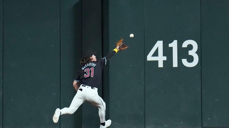 Arizona Diamondbacks center fielder Jake McCarthy make a running catch...