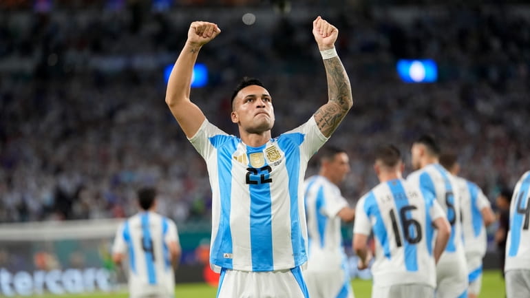 Argentina's Lautaro Martínez celebrates scoring his side's opening goal against...