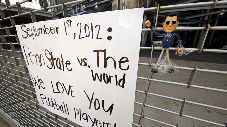 A sign and a small figure of former Penn State...