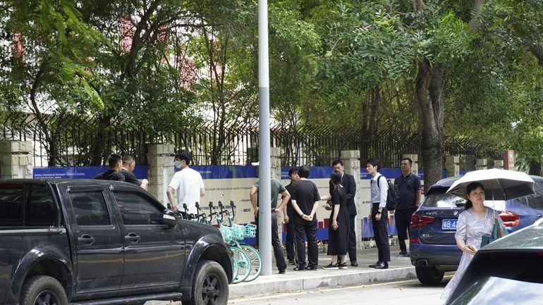 Chinese authorities inspect the scene of a stabbing at the...