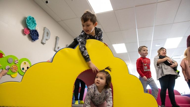 Mason Capiral, 6, and Willow Capiral, 1, from Smithtown, play together...