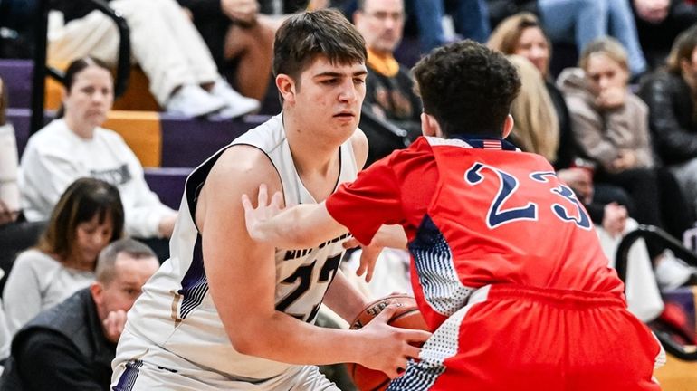 Richie Carmody of Sayville stares down the defense of John...