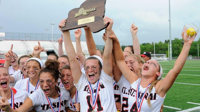 Mount Sinai midfielder Caroline Fitzgerald holds up the championship plaque...