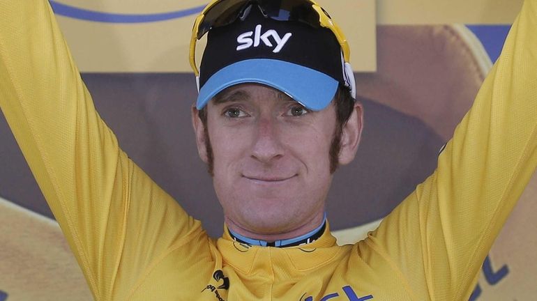 Bradley Wiggins of Britain, wearing the overall leader's yellow jersey,...