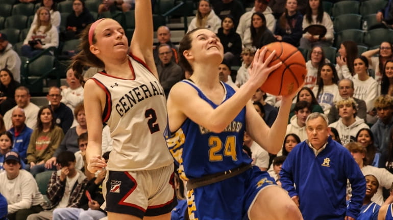 East Meadow's Charlotte Viola puts up the shot in front...