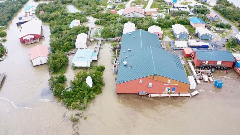 Water from an overflowing Kuskokwim River floods Napakiak, Alaska, Sunday,...