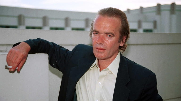Author Martin Amis poses for a photographer in June 2000 at...