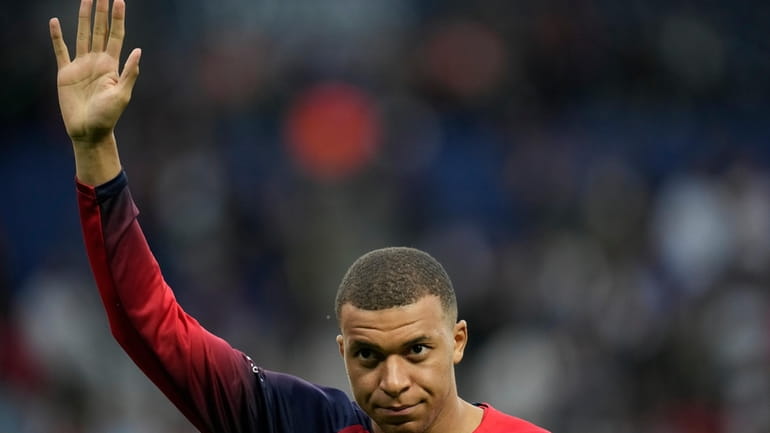 PSG's Kylian Mbappe greets supporters before the French League One...