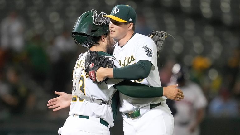 Oakland Athletics catcher Shea Langeliers, left, celebrates with pitcher Mason...