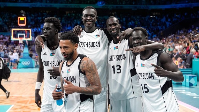 Members of the South Sudan team pose after they defeated...