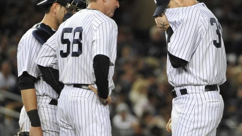 Yankees' pitching coach Dave Eiland comes to the mound with...