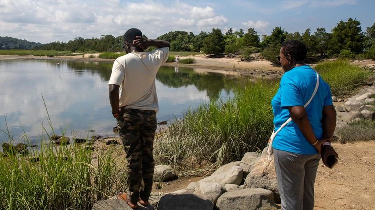 Stony Brook University grad student researcher Samuel Osei Poku, left,...