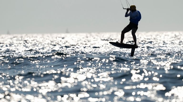 Ellie Aldridge of Britain celebrates after winning the women's kite...