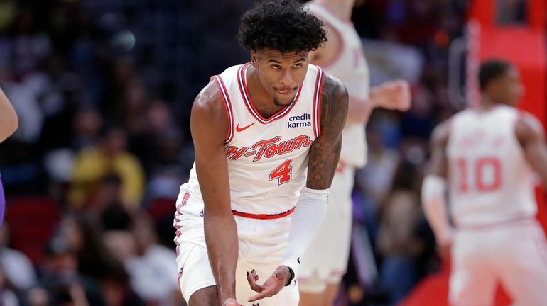 Houston Rockets guard Jalen Green reacts after sinking a three...