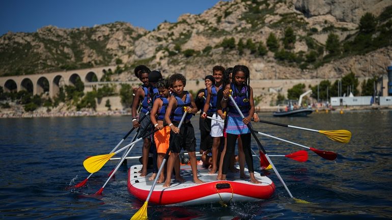 Children attend a swimming camp organized by the Grand Bleu...