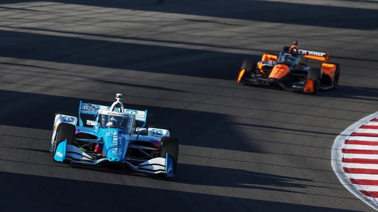 Josef Newgarden, left, drives during an IndyCar auto race on...