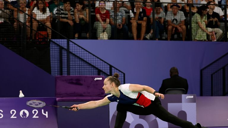 Oksana Kozyna, from Ukraine, lunges to hit the shuttlecock during...