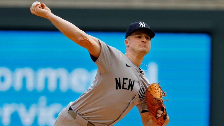 Yankees starting pitcher Clarke Schmidt throws to the Twins in...