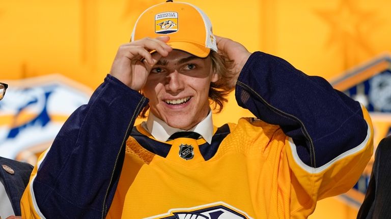 Tanner Molendyk puts on a Nashville Predators hat after being...