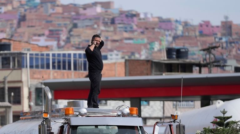 Truckers block a street to protest against a government-announced increase...