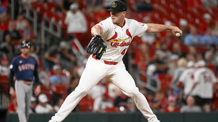 St. Louis Cardinals relief pitcher John King throws in the...