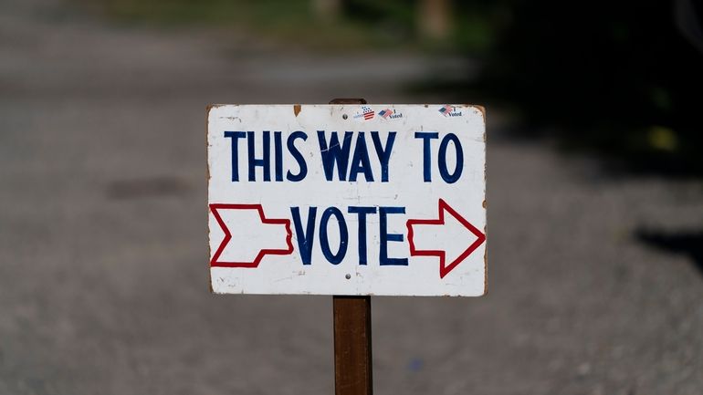 A sign stands outside a polling place during the Republican...