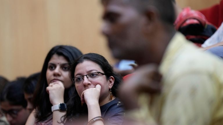 Delegates listen to a speaker during a 'People's Summit on...